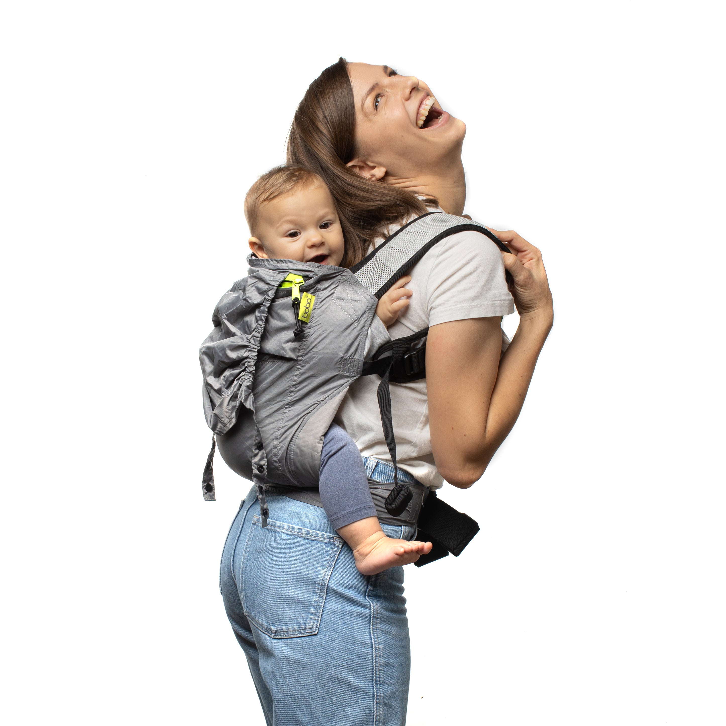 Mom laughing with her baby daughter on her back in an ergonomic back carry position in the gray boba air.