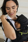 A lightweight, Boba Air Baby Travel Carrier with padded mesh straps, leg openings, adjustable shoulder straps, and an integrated hood. Compact and self-storing, it fits babies 4-24 months (15+ lbs) and children up to 45 lbs,  Black