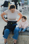 A lightweight, Boba Air Baby Travel Carrier with padded mesh straps, leg openings, adjustable shoulder straps, and an integrated hood. Compact and self-storing, it fits babies 4-24 months (15+ lbs) and children up to 45 lbs,  Black