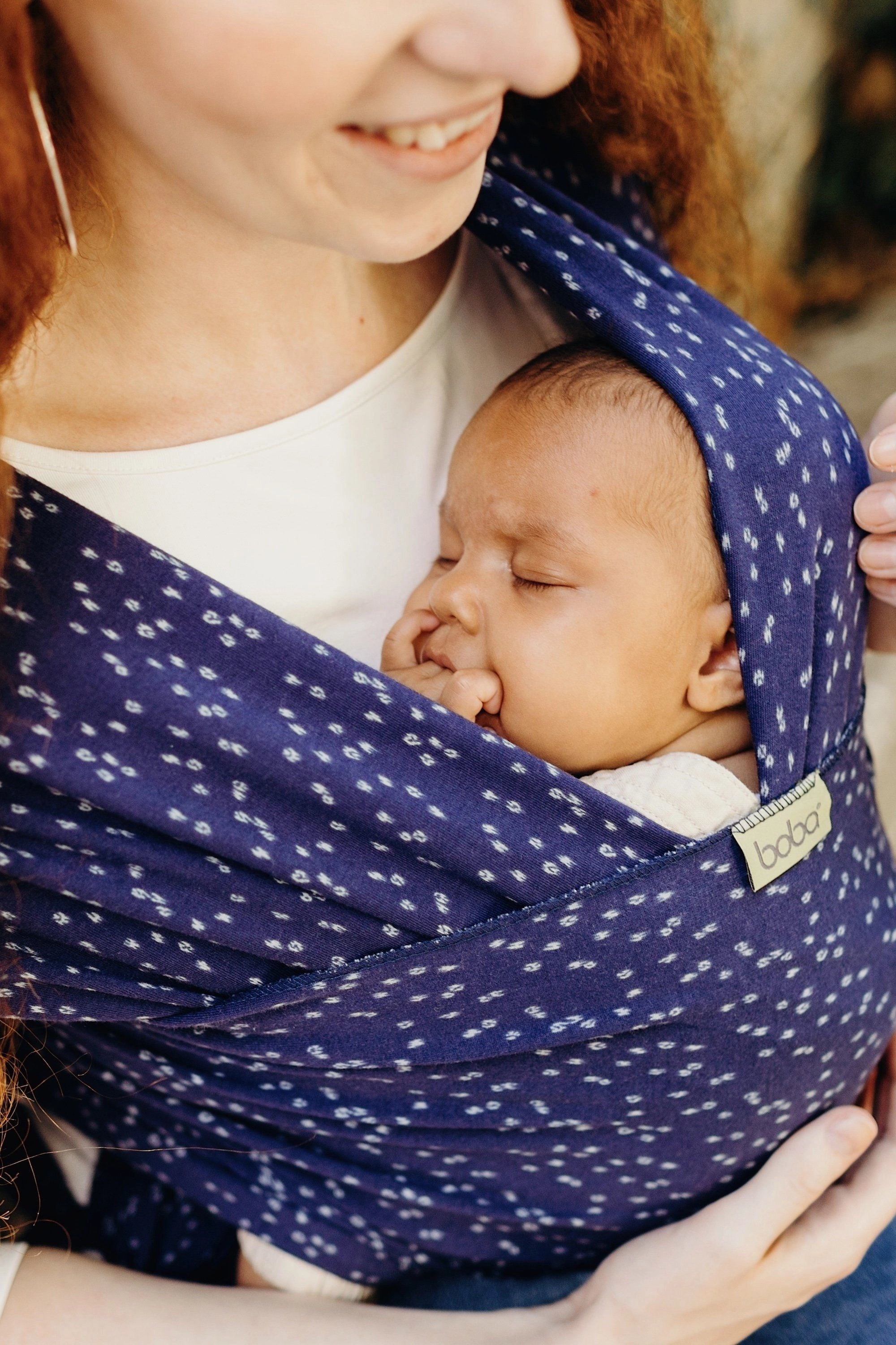 A Boba Classic Baby Wrap, made from a soft 95% French Terry cotton blend and 5% Spandex. Ergonomic, award-winning design fits babies from 7 Ibs to 35 Ibs, best up to 20 Ibs. Machine washable, dryer friendly, and certified hip-healthy. Plum Ikat