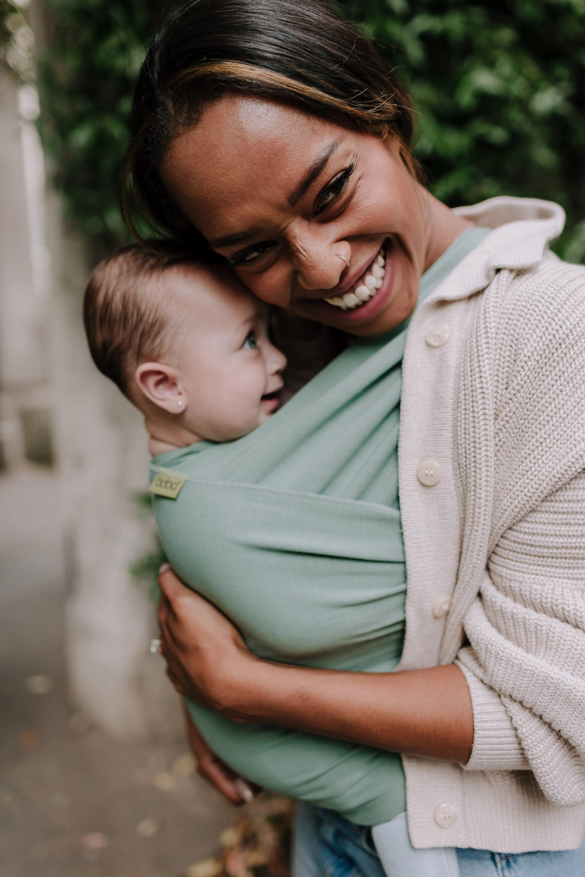 A Boba Classic Baby Wrap, made from a soft 95% French Terry cotton blend and 5% Spandex. Ergonomic, award-winning design fits babies from 7 Ibs to 35 Ibs, best up to 20 Ibs. Machine washable, dryer friendly, and certified hip-healthy. Sage Green