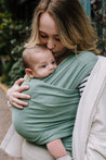 A Boba Classic Baby Wrap, made from a soft 95% French Terry cotton blend and 5% Spandex. Ergonomic, award-winning design fits babies from 7 Ibs to 35 Ibs, best up to 20 Ibs. Machine washable, dryer friendly, and certified hip-healthy. Sage Green