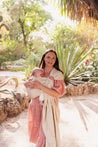 A Boba Ring Sling Baby Carrier made from a unique linen bamboo viscose fabric blend, perfect for all seasons. Lightweight and breathable, it stores compactly, ideal for newborn snuggles to toddler ups and downs (8 - 35Ibs). Pampas Beige