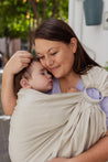 A Boba Ring Sling Baby Carrier made from a unique linen bamboo viscose fabric blend, perfect for all seasons. Lightweight and breathable, it stores compactly, ideal for newborn snuggles to toddler ups and downs (8 - 35Ibs). Pampas Beige