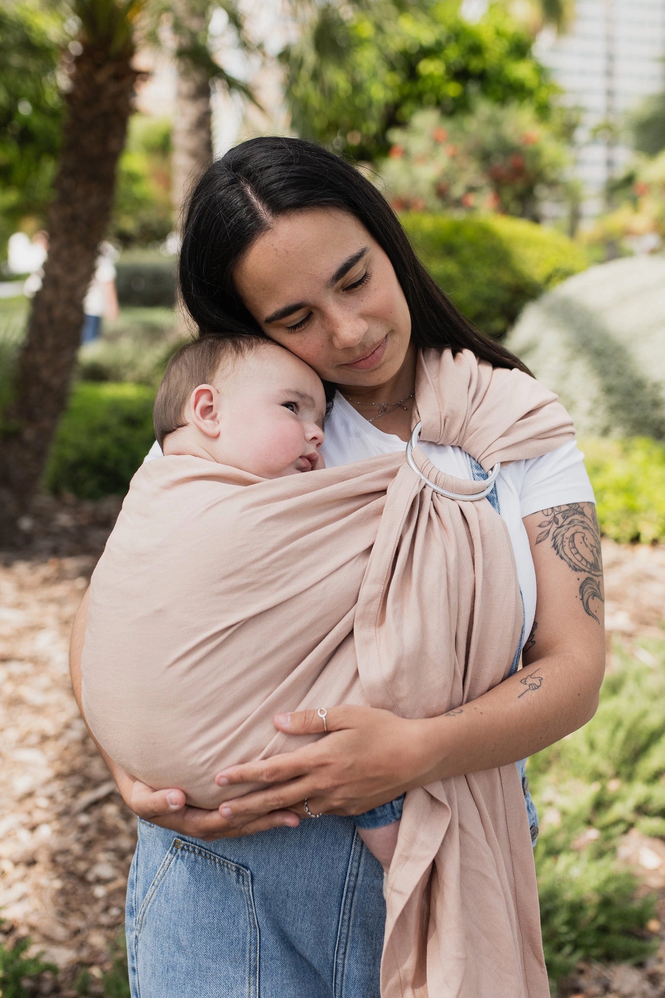 A Boba Ring Sling Baby Carrier made from a unique linen bamboo viscose fabric blend, perfect for all seasons. Lightweight and breathable, it stores compactly, ideal for newborn snuggles to toddler ups and downs (8 - 35Ibs).  Peony Pink