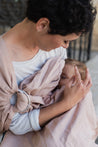 A Boba Ring Sling Baby Carrier made from a unique linen bamboo viscose fabric blend, perfect for all seasons. Lightweight and breathable, it stores compactly, ideal for newborn snuggles to toddler ups and downs (8 - 35Ibs).  Peony Pink