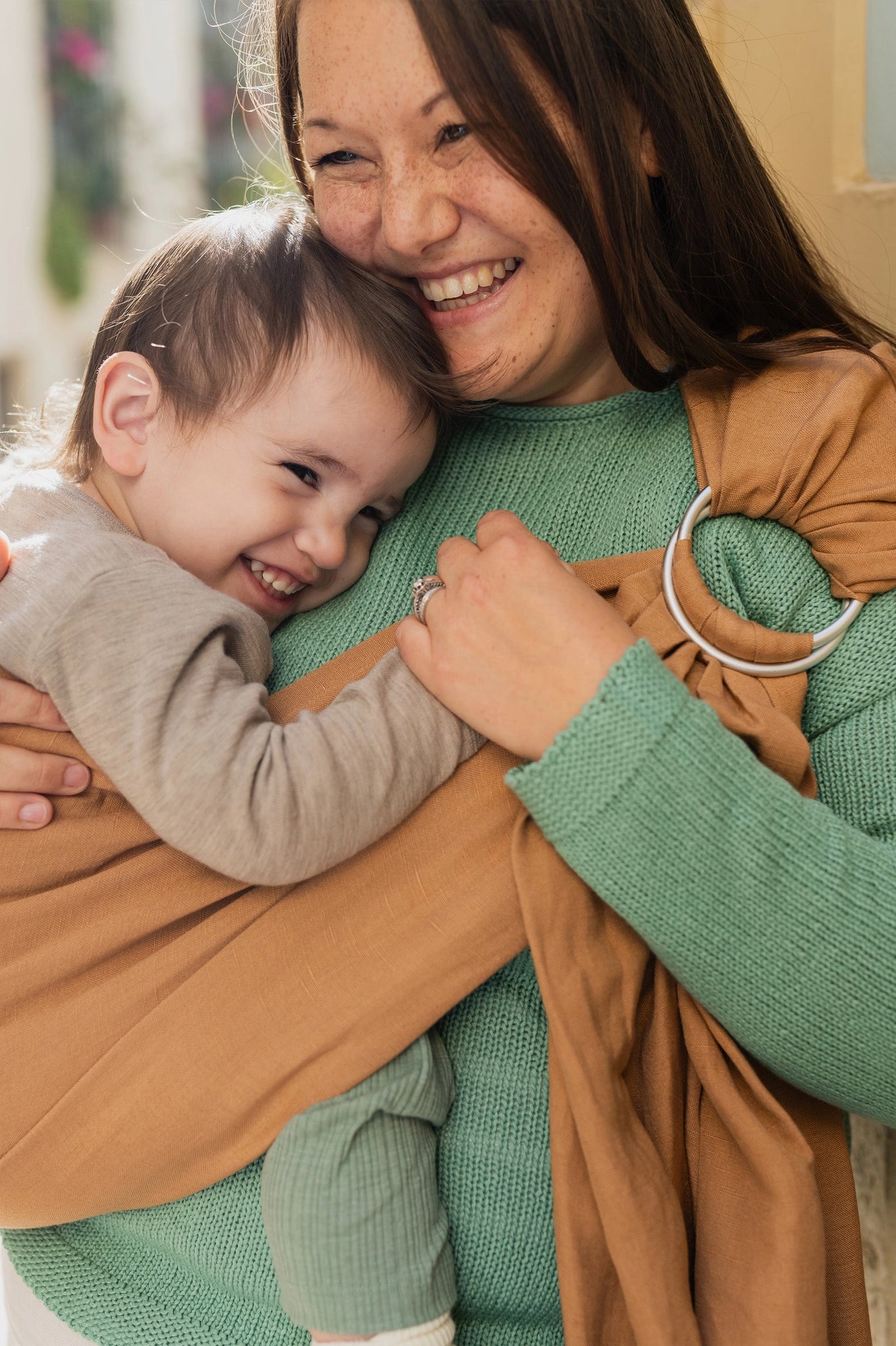 A Boba Ring Sling Baby Carrier made from a unique linen bamboo viscose fabric blend, perfect for all seasons. Lightweight and breathable, it stores compactly, ideal for newborn snuggles to toddler ups and downs (8 - 35Ibs). Rye Brown