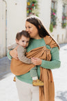 A Boba Ring Sling Baby Carrier made from a unique linen bamboo viscose fabric blend, perfect for all seasons. Lightweight and breathable, it stores compactly, ideal for newborn snuggles to toddler ups and downs (8 - 35Ibs). Rye Brown