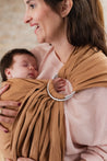 A Boba Ring Sling Baby Carrier made from a unique linen bamboo viscose fabric blend, perfect for all seasons. Lightweight and breathable, it stores compactly, ideal for newborn snuggles to toddler ups and downs (8 - 35Ibs). Rye Brown