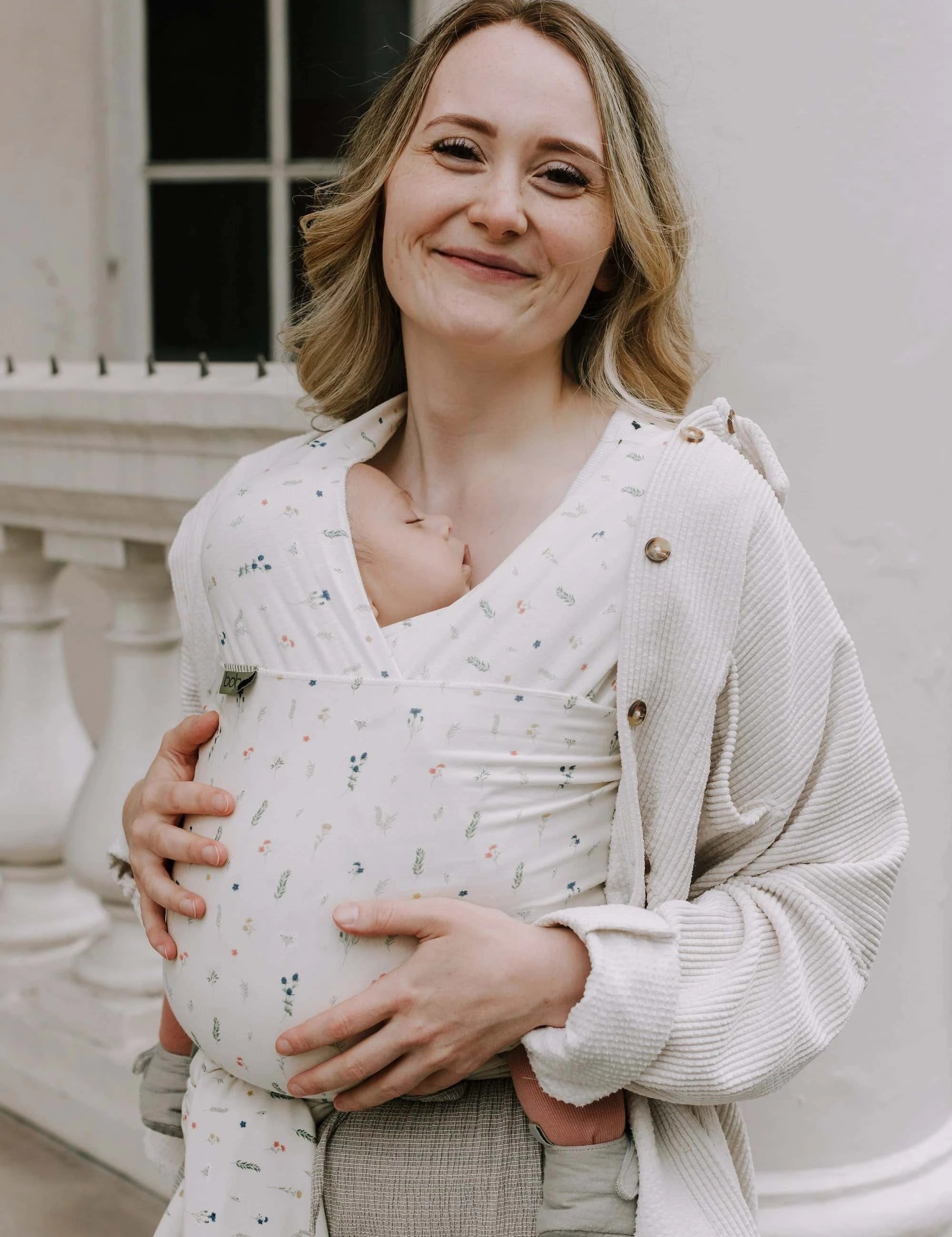 A Boba Serenity Baby Wrap, made from a buttery soft, extra breathable bamboo blend fabric (68% Viscose from Bamboo, 25% Cotton, 7% Spandex). Ergonomic, award-winning design fits babies from 7 Ibs to 35 Ibs, best up to 20 Ibs. Machine washable, dryer friendly, and certified hip-healthy. Achillea