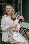 A Boba Serenity Baby Wrap, made from a buttery soft, extra breathable bamboo blend fabric (68% Viscose from Bamboo, 25% Cotton, 7% Spandex). Ergonomic, award-winning design fits babies from 7 Ibs to 35 Ibs, best up to 20 Ibs. Machine washable, dryer friendly, and certified hip-healthy. Achillea