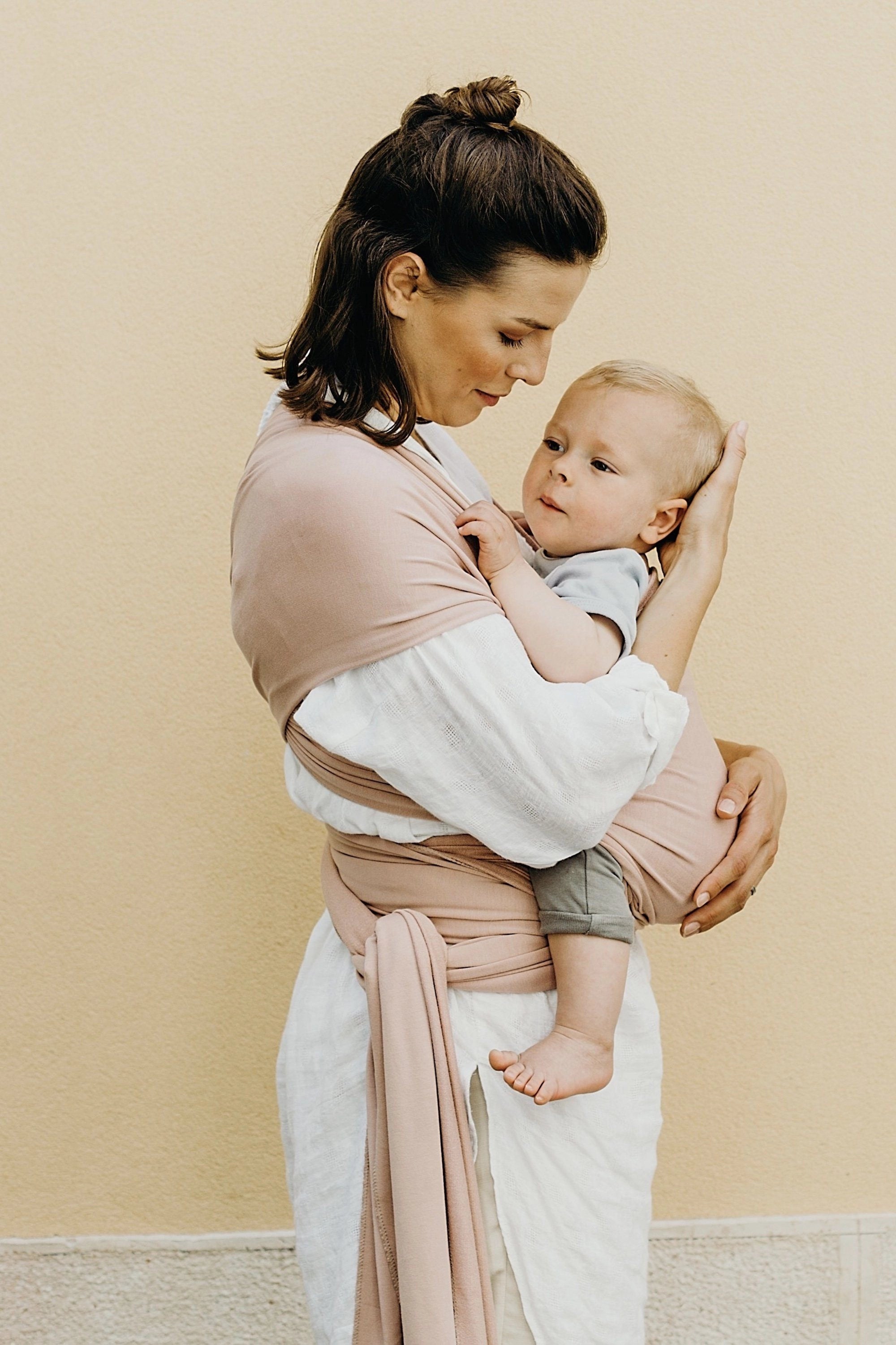 A Boba Serenity Baby Wrap, made from a buttery soft, extra breathable bamboo blend fabric (68% Viscose from Bamboo, 25% Cotton, 7% Spandex). Ergonomic, award-winning design fits babies from 7 Ibs to 35 Ibs, best up to 20 Ibs. Machine washable, dryer friendly, and certified hip-healthy. Bloom