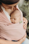 A Boba Serenity Baby Wrap, made from a buttery soft, extra breathable bamboo blend fabric (68% Viscose from Bamboo, 25% Cotton, 7% Spandex). Ergonomic, award-winning design fits babies from 7 Ibs to 35 Ibs, best up to 20 Ibs. Machine washable, dryer friendly, and certified hip-healthy. Bloom