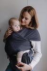 A Boba Serenity Baby Wrap, made from a buttery soft, extra breathable bamboo blend fabric (68% Viscose from Bamboo, 25% Cotton, 7% Spandex). Ergonomic, award-winning design fits babies from 7 Ibs to 35 Ibs, best up to 20 Ibs. Machine washable, dryer friendly, and certified hip-healthy. Charcoal