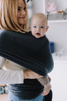 A Boba Serenity Baby Wrap, made from a buttery soft, extra breathable bamboo blend fabric (68% Viscose from Bamboo, 25% Cotton, 7% Spandex). Ergonomic, award-winning design fits babies from 7 Ibs to 35 Ibs, best up to 20 Ibs. Machine washable, dryer friendly, and certified hip-healthy. Charcoal