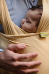 A Boba Serenity Baby Wrap, made from a buttery soft, extra breathable bamboo blend fabric (68% Viscose from Bamboo, 25% Cotton, 7% Spandex). Ergonomic, award-winning design fits babies from 7 Ibs to 35 Ibs, best up to 20 Ibs. Machine washable, dryer friendly, and certified hip-healthy. Flax