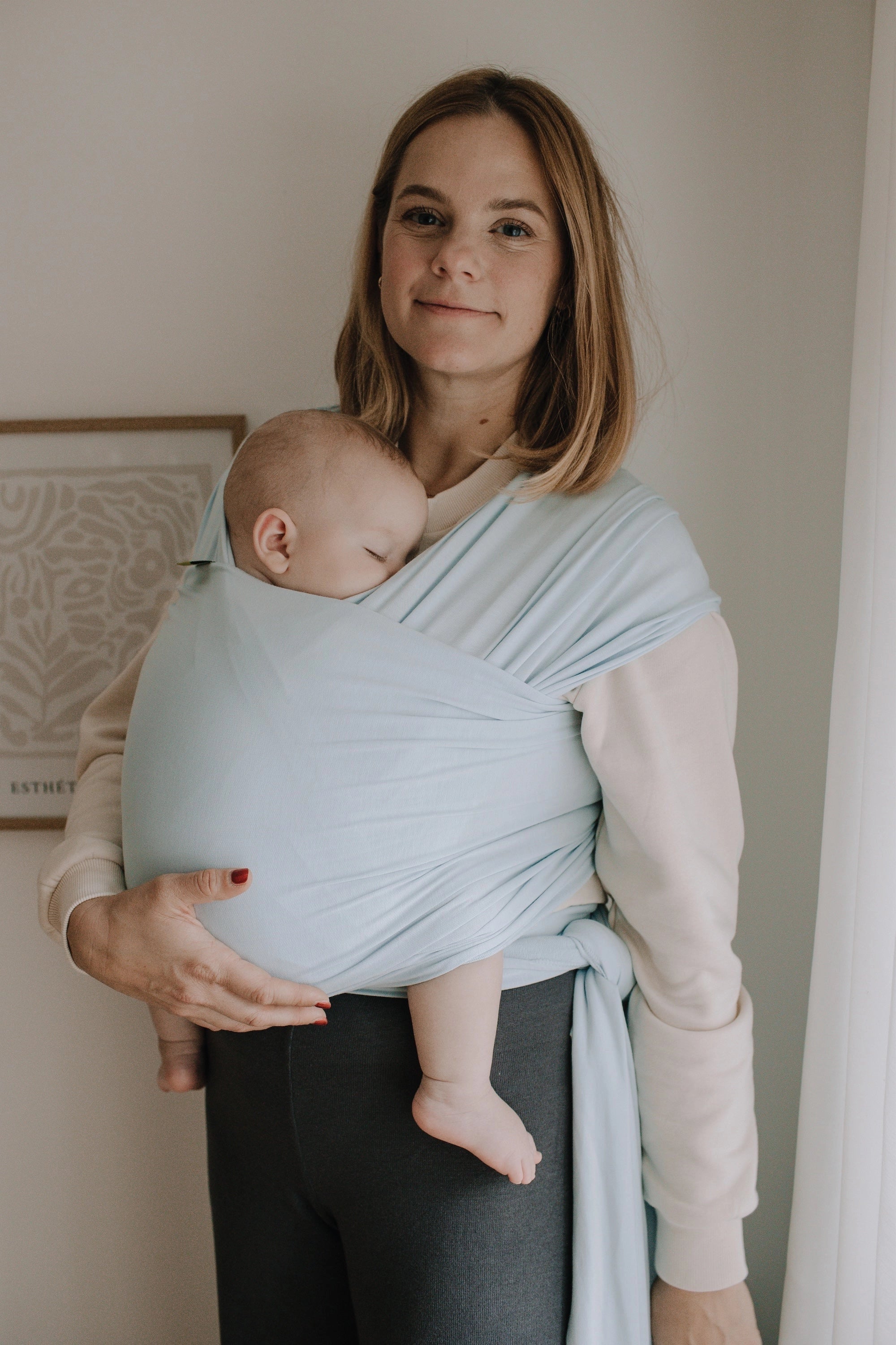 A Boba Serenity Baby Wrap, made from a buttery soft, extra breathable bamboo blend fabric (68% Viscose from Bamboo, 25% Cotton, 7% Spandex). Ergonomic, award-winning design fits babies from 7 Ibs to 35 Ibs, best up to 20 Ibs. Machine washable, dryer friendly, and certified hip-healthy. Light Blue