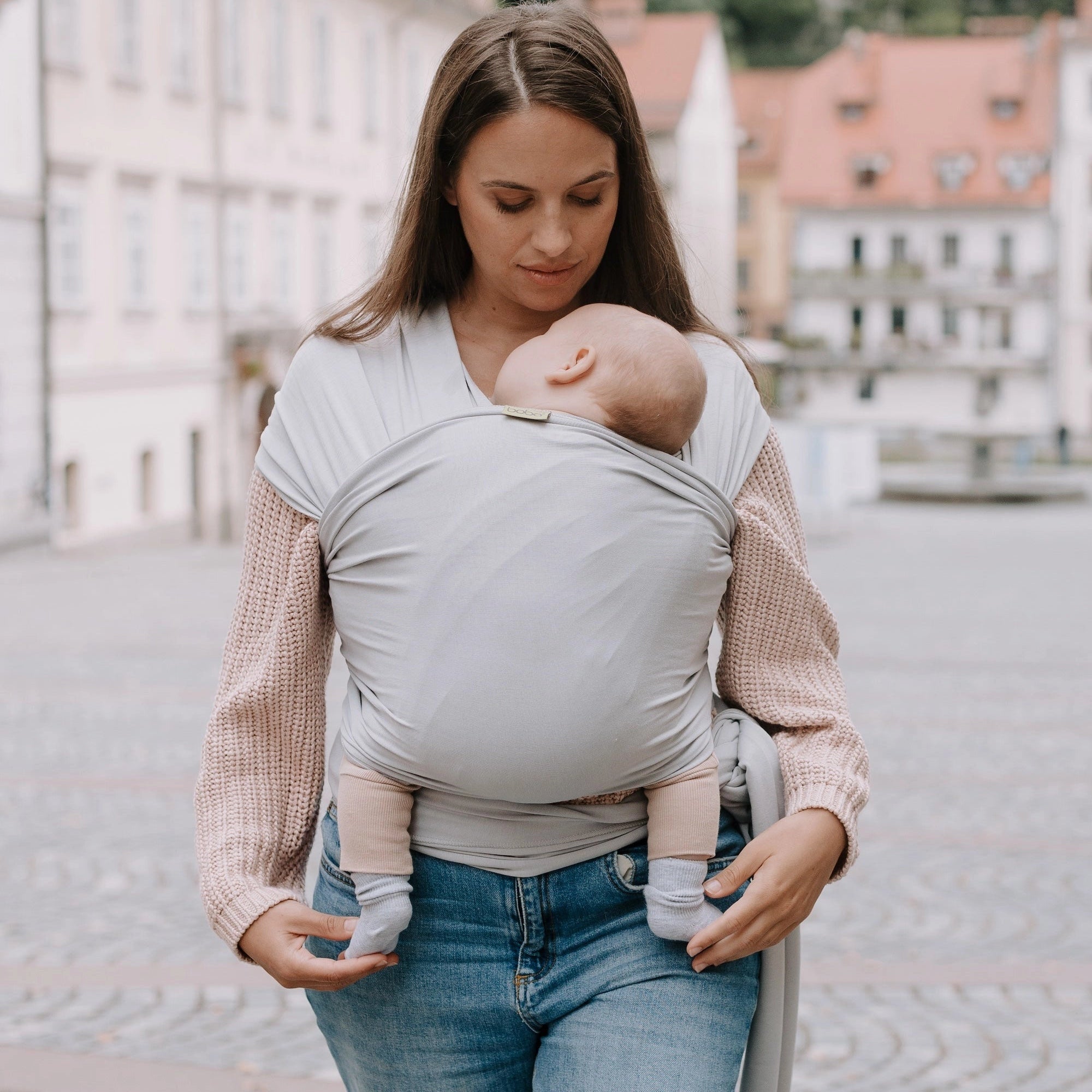 A Boba Serenity Baby Wrap, made from a buttery soft, extra breathable bamboo blend fabric (68% Viscose from Bamboo, 25% Cotton, 7% Spandex). Ergonomic, award-winning design fits babies from 7 Ibs to 35 Ibs, best up to 20 Ibs. Machine washable, dryer friendly, and certified hip-healthy. Light Gray