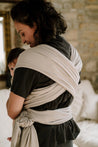 A Boba Serenity Baby Wrap, made from a buttery soft, extra breathable bamboo blend fabric (68% Viscose from Bamboo, 25% Cotton, 7% Spandex). Ergonomic, award-winning design fits babies from 7 Ibs to 35 Ibs, best up to 20 Ibs. Machine washable, dryer friendly, and certified hip-healthy. Light Gray