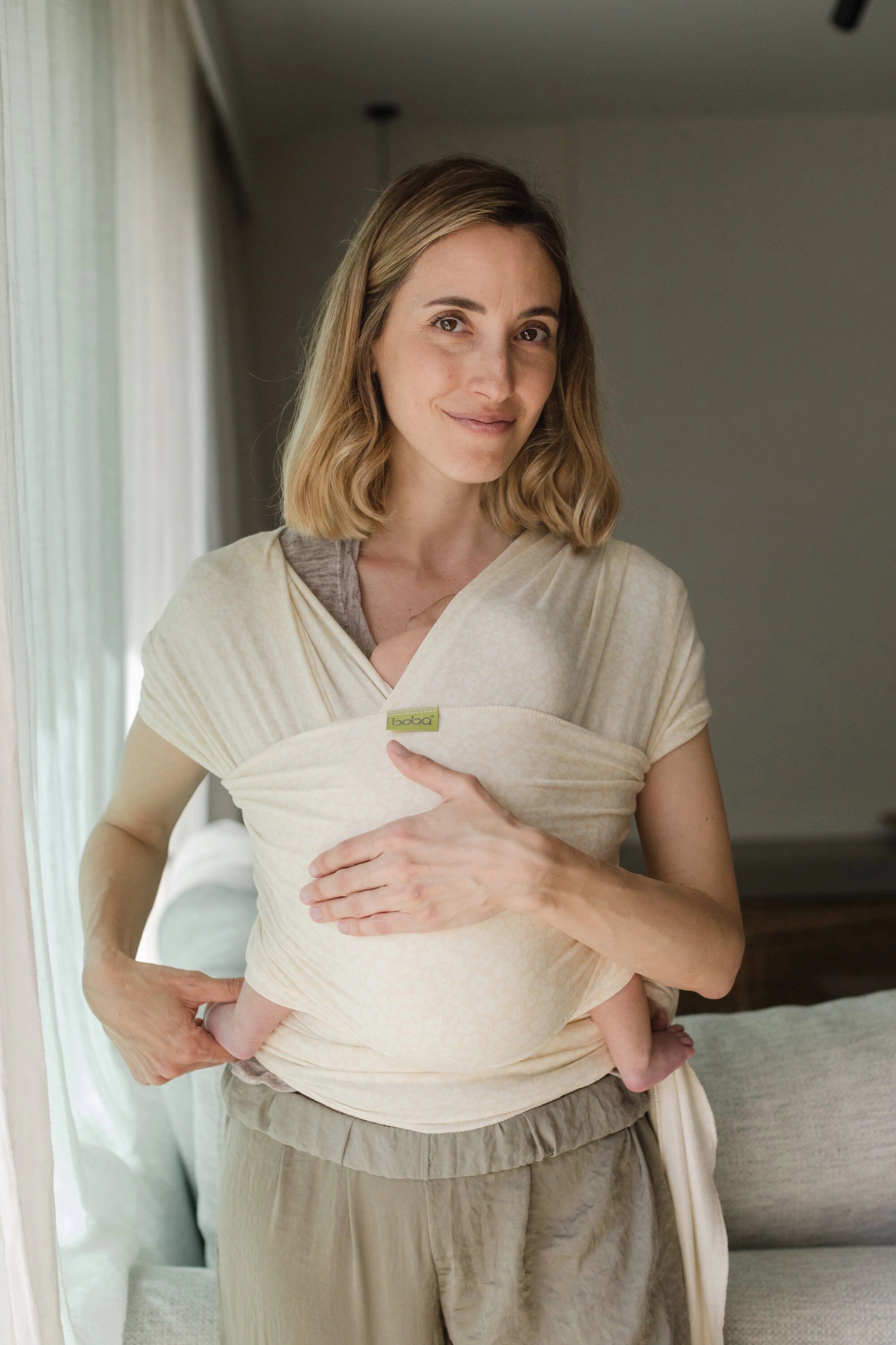 A Boba Serenity Baby Wrap, made from a buttery soft, extra breathable bamboo blend fabric (68% Viscose from Bamboo, 25% Cotton, 7% Spandex). Ergonomic, award-winning design fits babies from 7 Ibs to 35 Ibs, best up to 20 Ibs. Machine washable, dryer friendly, and certified hip-healthy. Oat Meadow