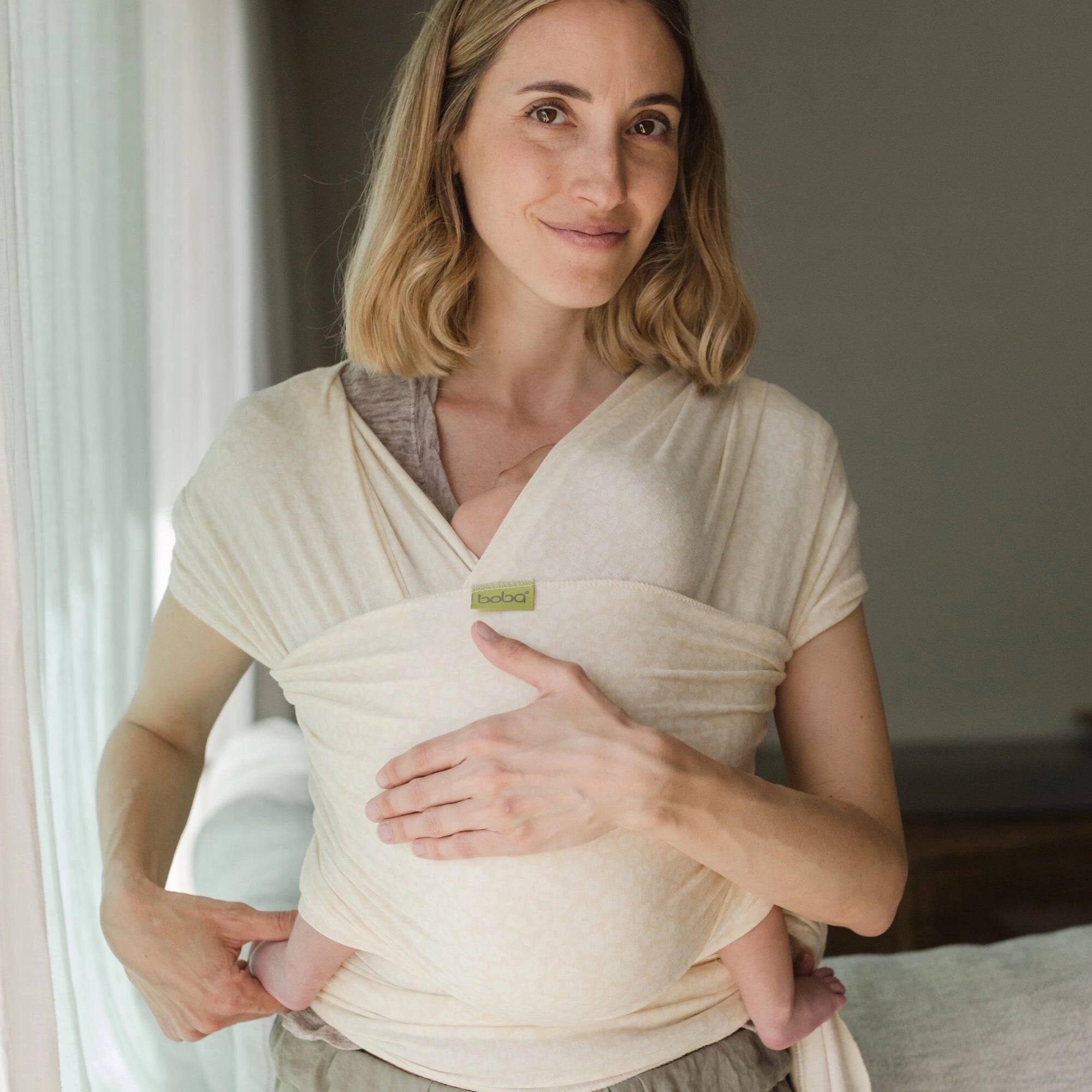 A Boba Serenity Baby Wrap, made from a buttery soft, extra breathable bamboo blend fabric (68% Viscose from Bamboo, 25% Cotton, 7% Spandex). Ergonomic, award-winning design fits babies from 7 Ibs to 35 Ibs, best up to 20 Ibs. Machine washable, dryer friendly, and certified hip-healthy. Oat Meadow