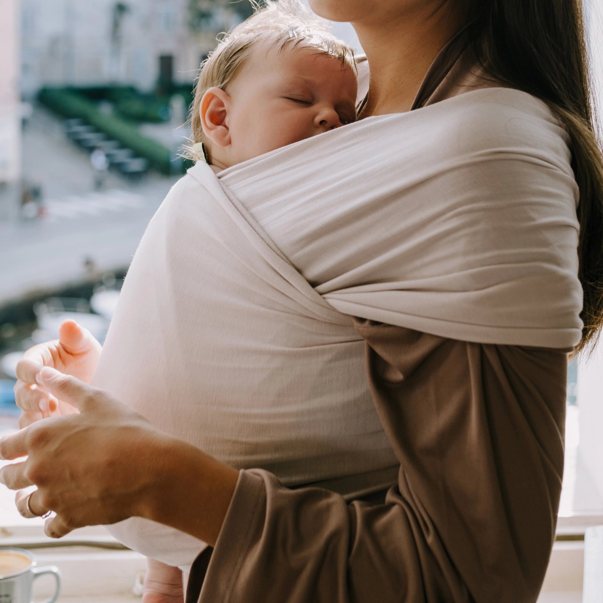 A Boba Serenity Baby Wrap, made from a buttery soft, extra breathable bamboo blend fabric (68% Viscose from Bamboo, 25% Cotton, 7% Spandex). Ergonomic, award-winning design fits babies from 7 Ibs to 35 Ibs, best up to 20 Ibs. Machine washable, dryer friendly, and certified hip-healthy. Organic Stone