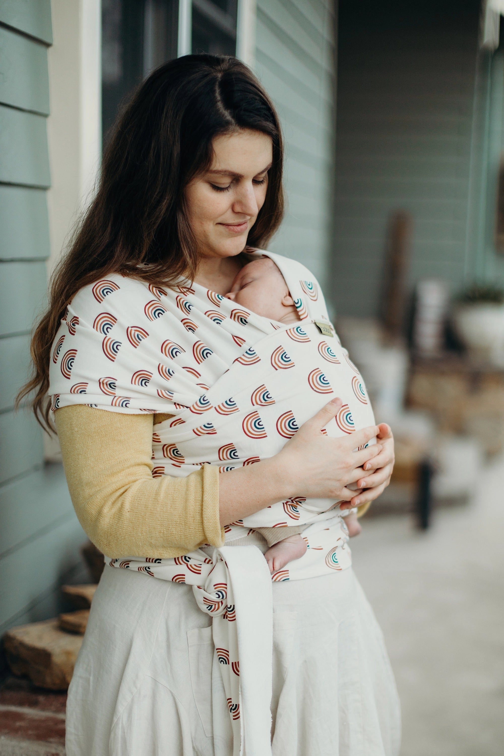 A Boba Serenity Baby Wrap, made from a buttery soft, extra breathable bamboo blend fabric (68% Viscose from Bamboo, 25% Cotton, 7% Spandex). Ergonomic, award-winning design fits babies from 7 Ibs to 35 Ibs, best up to 20 Ibs. Machine washable, dryer friendly, and certified hip-healthy. Rainbows