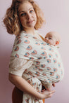 A Boba Serenity Baby Wrap, made from a buttery soft, extra breathable bamboo blend fabric (68% Viscose from Bamboo, 25% Cotton, 7% Spandex). Ergonomic, award-winning design fits babies from 7 Ibs to 35 Ibs, best up to 20 Ibs. Machine washable, dryer friendly, and certified hip-healthy. Rainbows