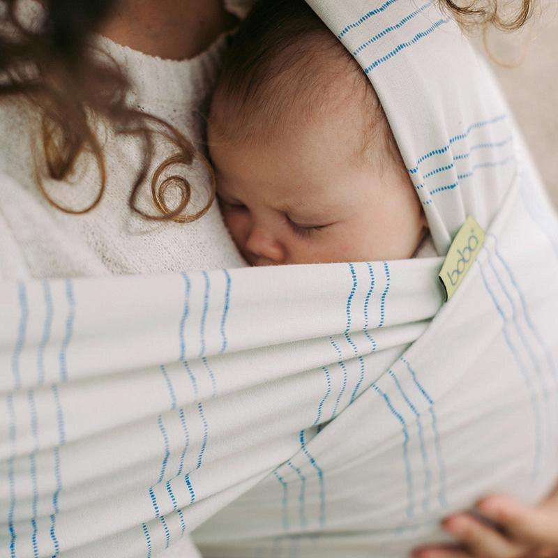 A Boba Serenity Baby Wrap, made from a buttery soft, extra breathable bamboo blend fabric (68% Viscose from Bamboo, 25% Cotton, 7% Spandex). Ergonomic, award-winning design fits babies from 7 Ibs to 35 Ibs, best up to 20 Ibs. Machine washable, dryer friendly, and certified hip-healthy. Riviera