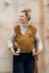 A Boba Serenity Baby Wrap, made from a buttery soft, extra breathable bamboo blend fabric (68% Viscose from Bamboo, 25% Cotton, 7% Spandex). Ergonomic, award-winning design fits babies from 7 Ibs to 35 Ibs, best up to 20 Ibs. Machine washable, dryer friendly, and certified hip-healthy. Tiger's Eye