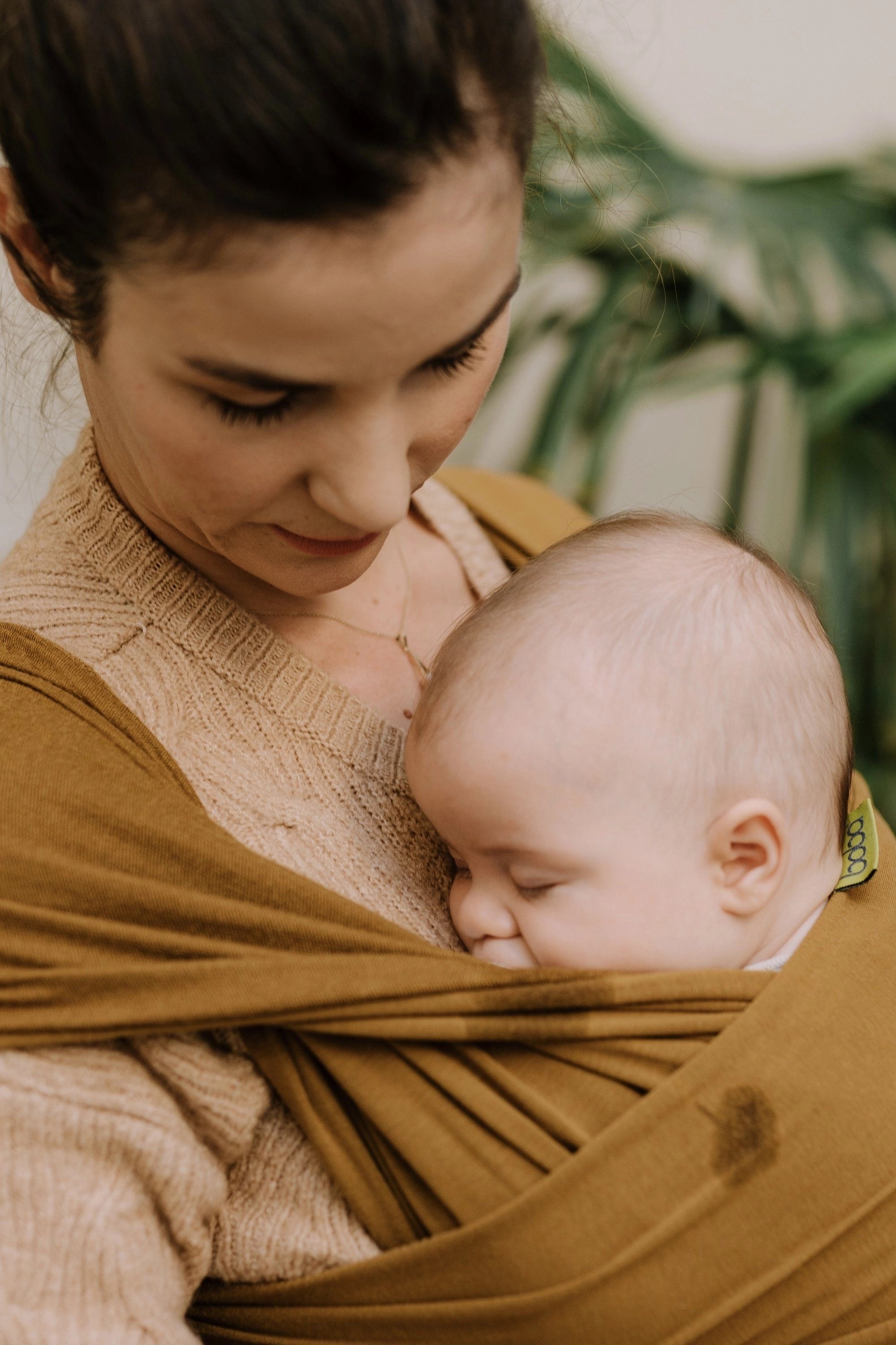 A Boba Serenity Baby Wrap, made from a buttery soft, extra breathable bamboo blend fabric (68% Viscose from Bamboo, 25% Cotton, 7% Spandex). Ergonomic, award-winning design fits babies from 7 Ibs to 35 Ibs, best up to 20 Ibs. Machine washable, dryer friendly, and certified hip-healthy. Tiger's Eye