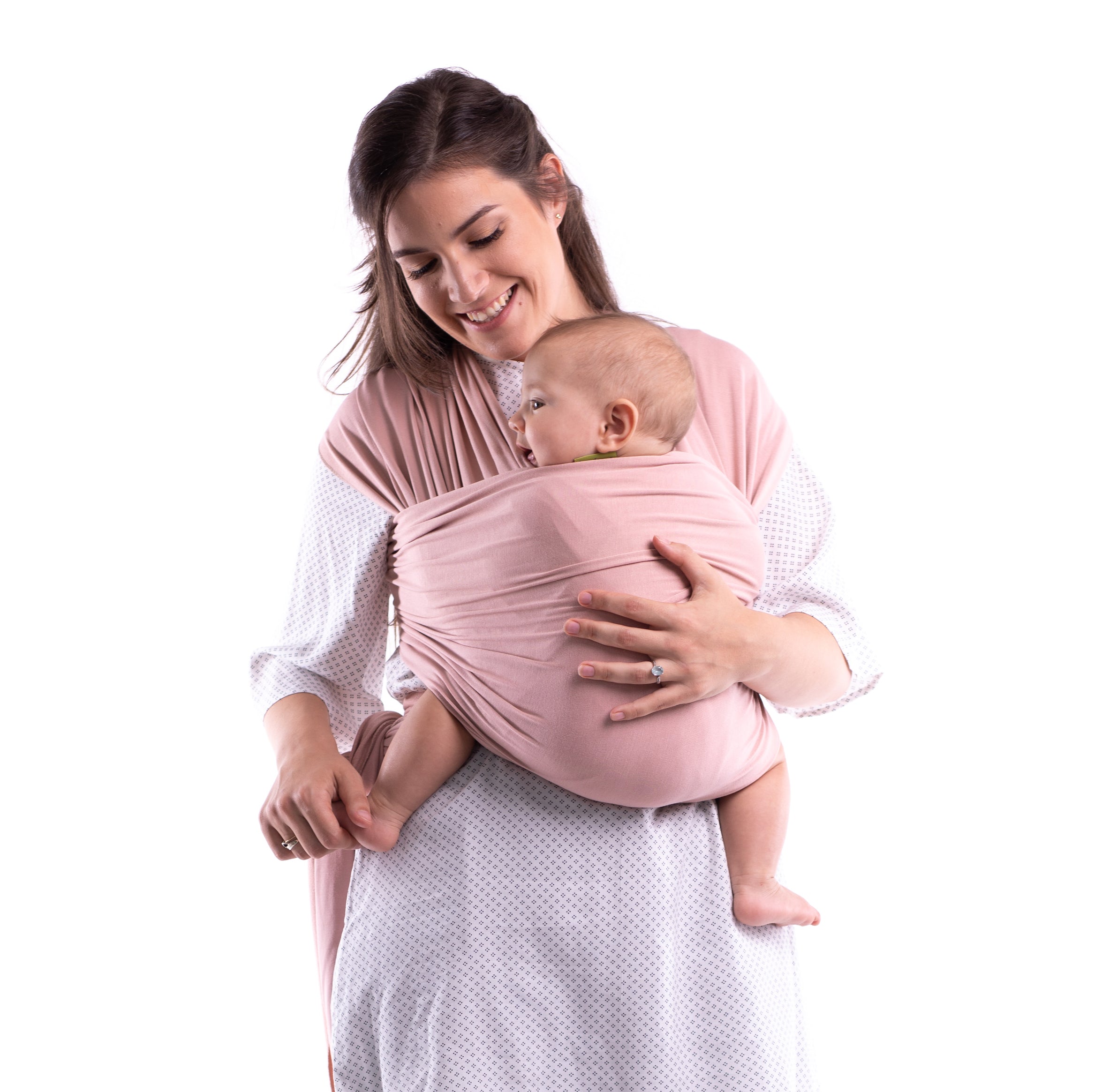 Happy smiling mom has her baby in a front wrap carry in the blush pink bamboo Serenity Wrap Bloom.